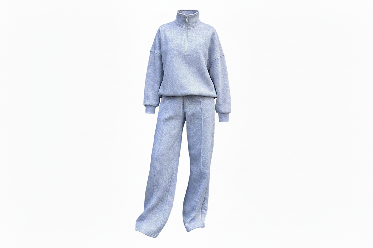 Light blue quarter-zip sweatsuit set with wide-leg pants on ghost mannequin